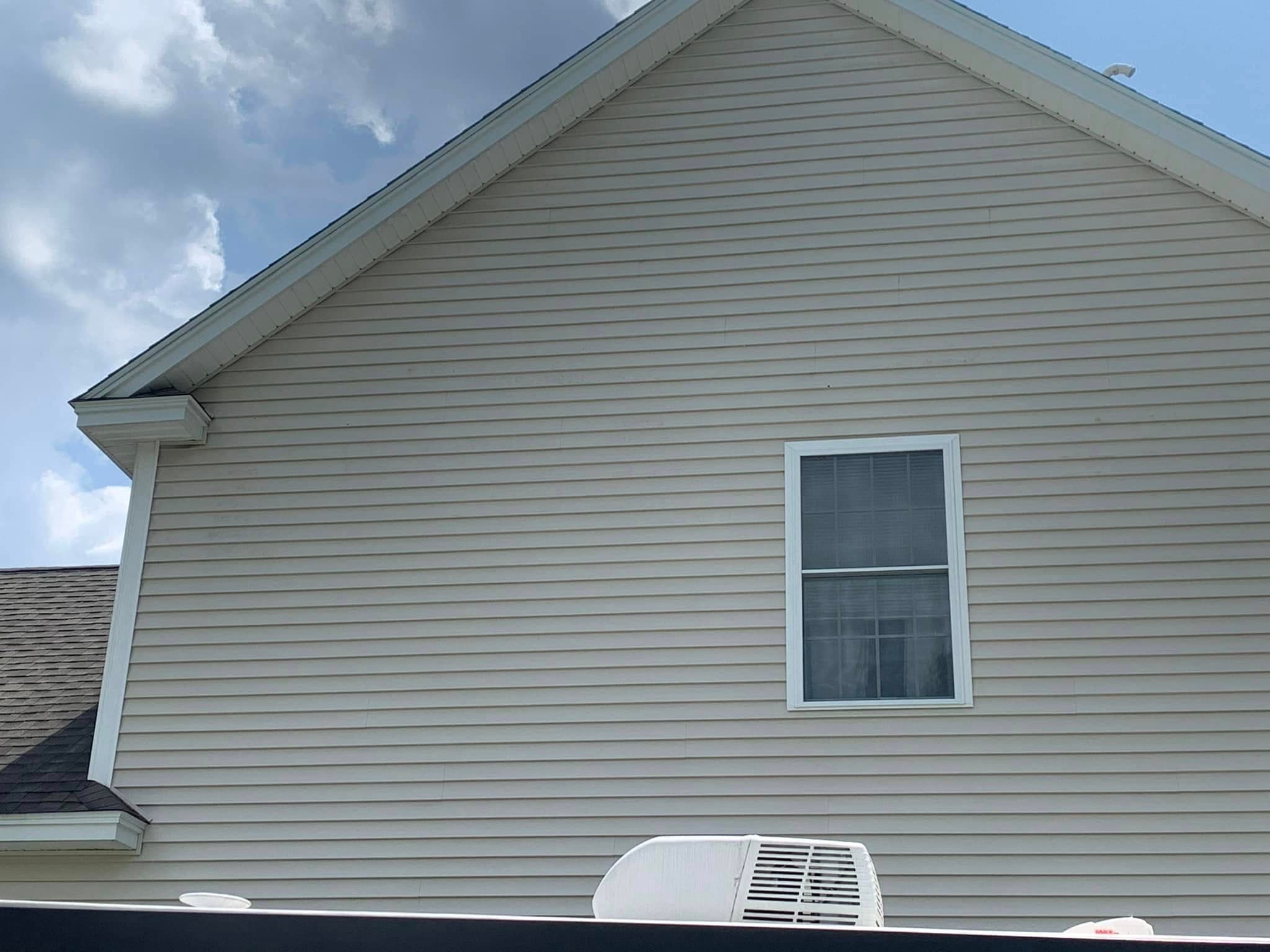 Clean home exterior siding after pressure washing